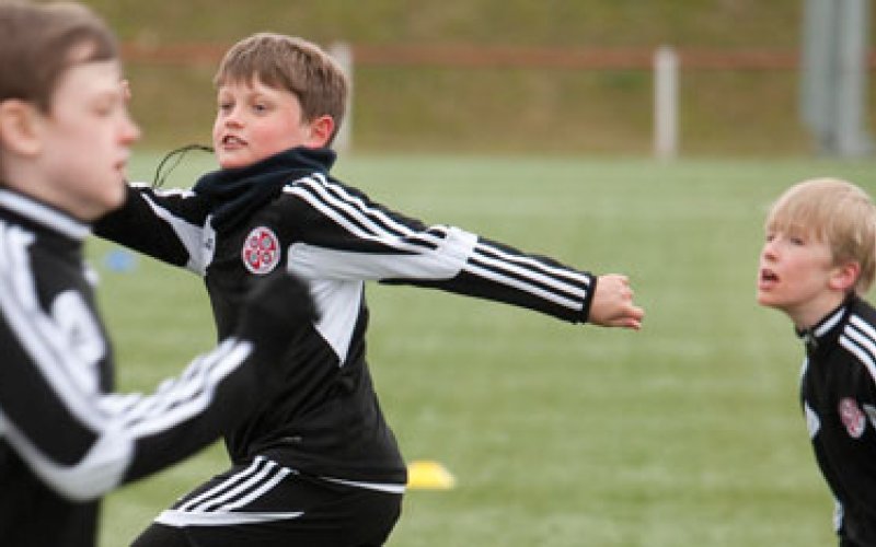 3 boys playing football