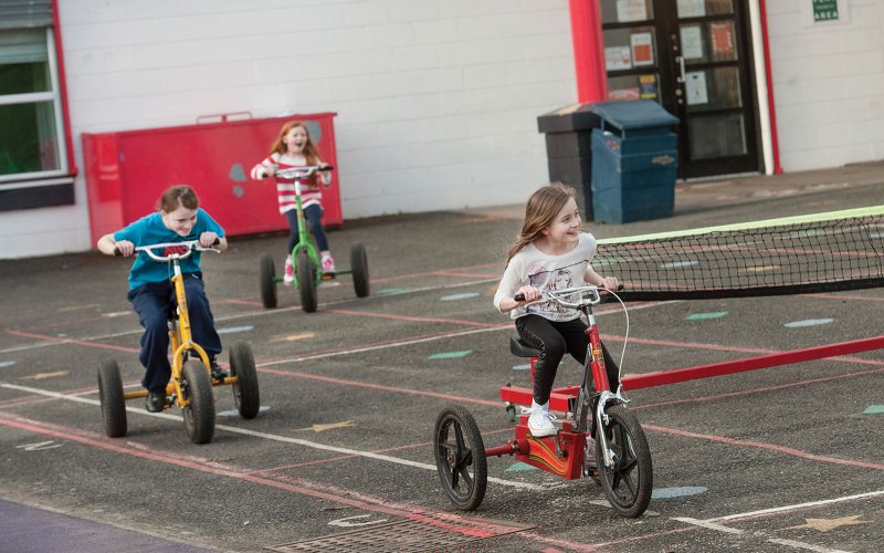 Children riding a tricycles